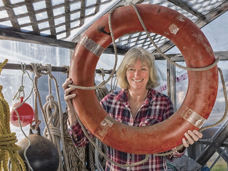 smiling woman holding round life preserver